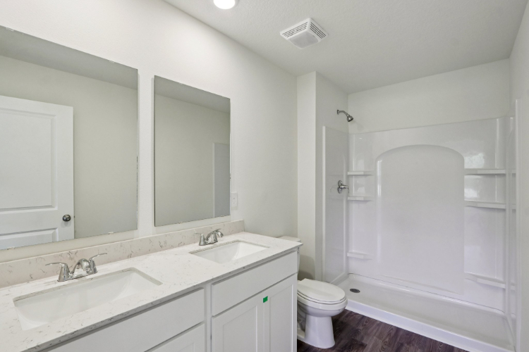 A bathroom with a tub sink and toilet.