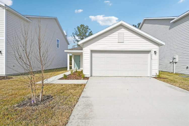 A driveway leading to a house.