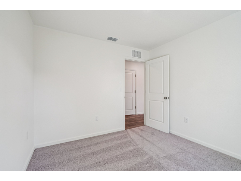 A hallway with white doors.