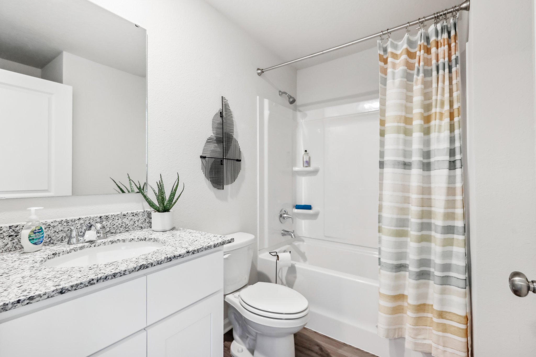 A bathroom with a shower and toilet.