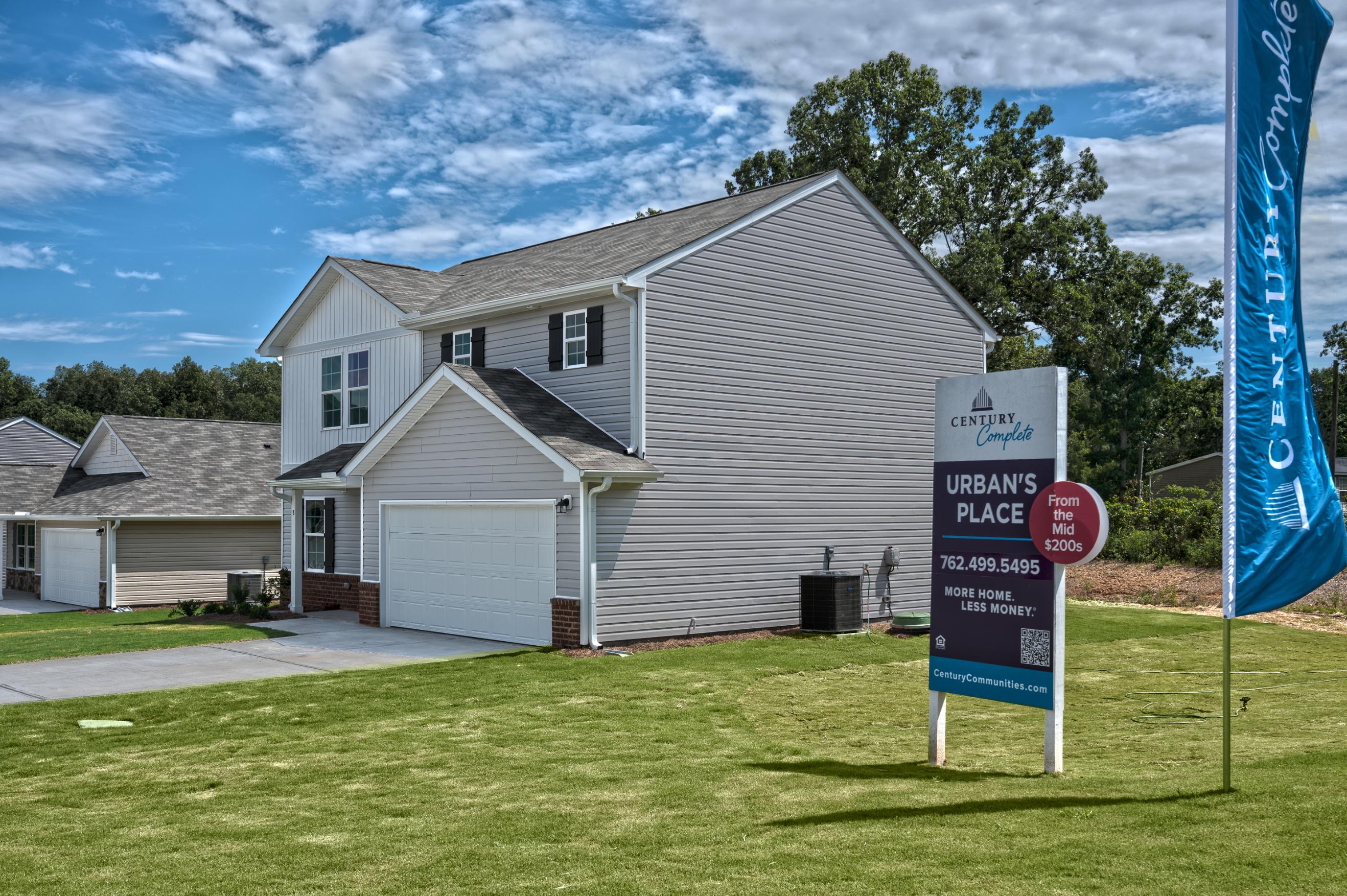 A house with a sign in front of it.