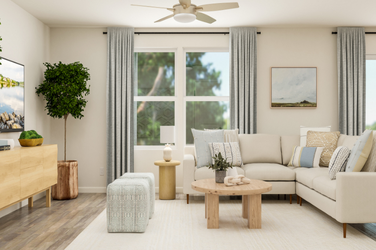 A living room with a white couch and a white table.