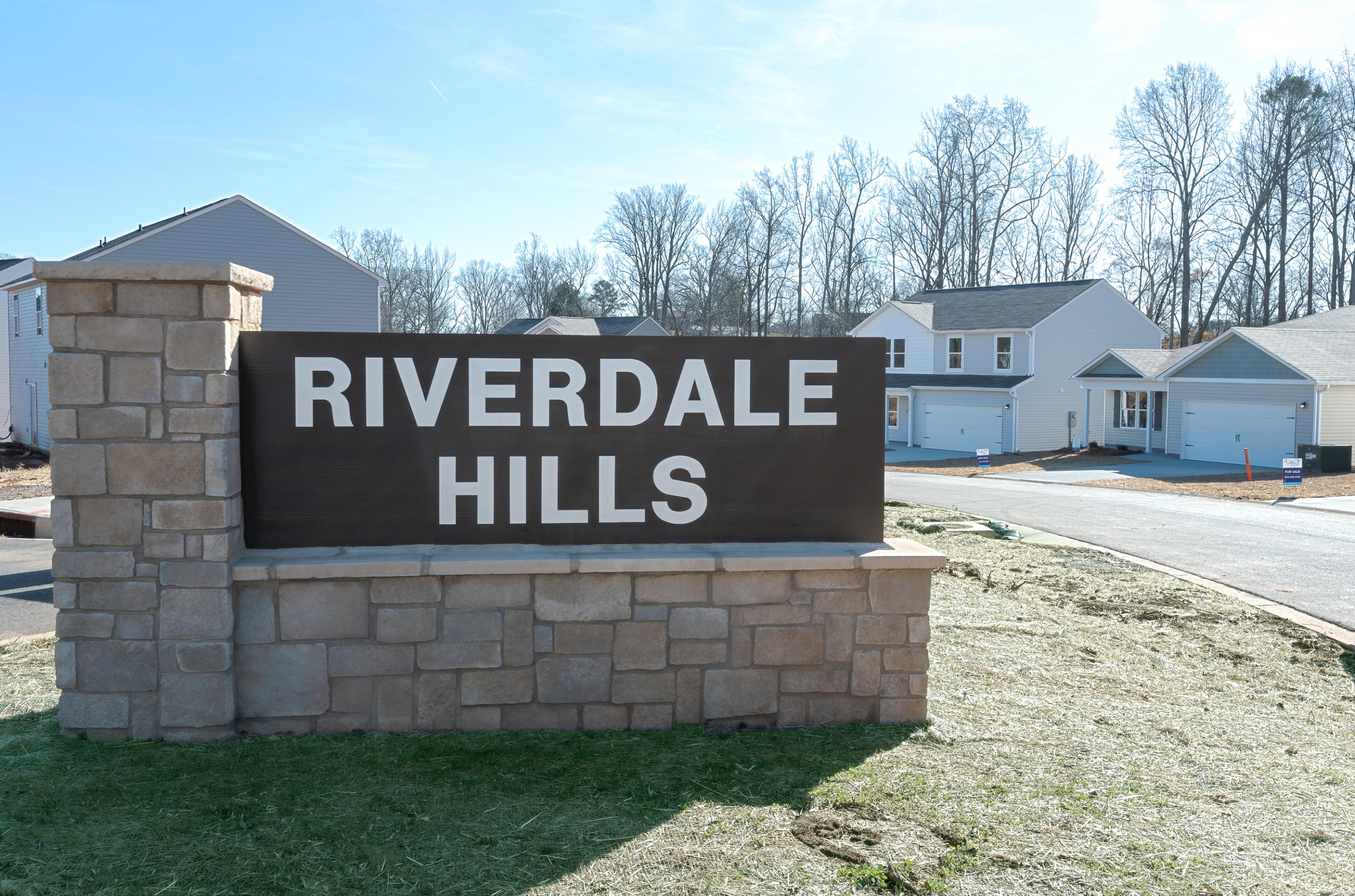 A sign on a brick wall.